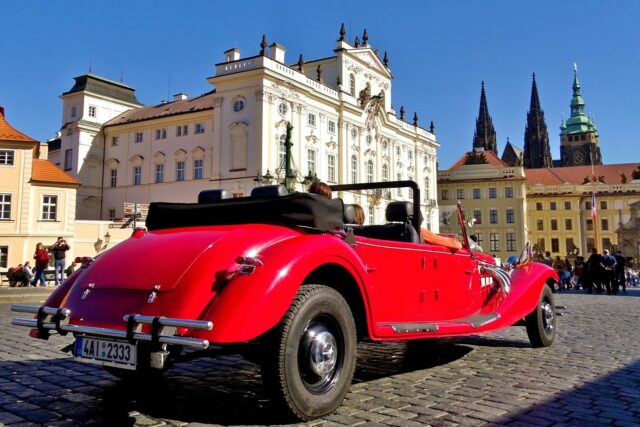 Historical car in front of the Prague Castle