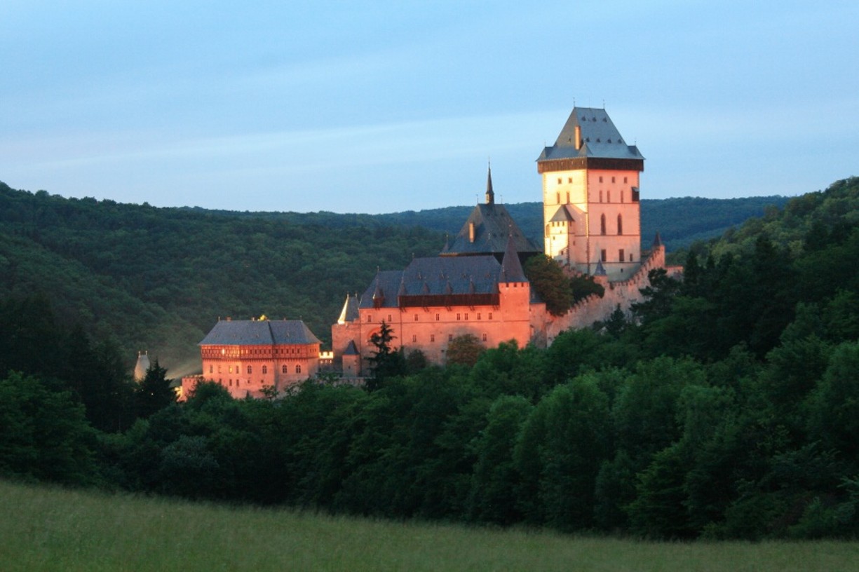 Sun setting on Karlštejn Castle, a beautiful scene to end the day and the perfect day trip from Prague.